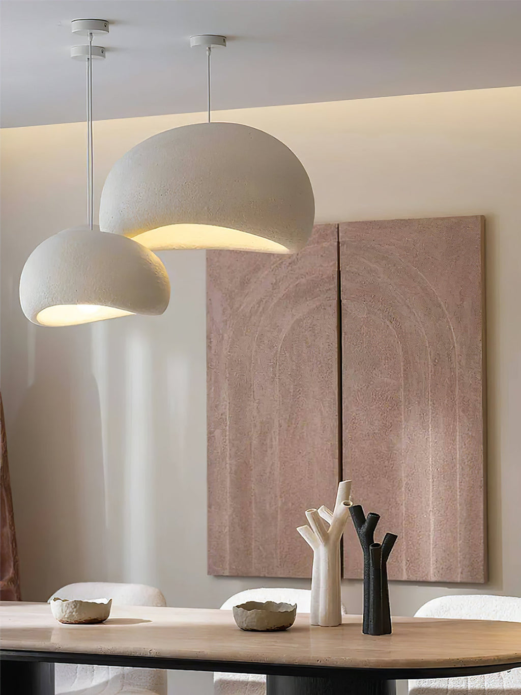 Round cloud pendant light glowing above a calm interior space