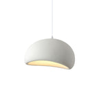 Cloud-shaped pendant light hanging above a neutral interior