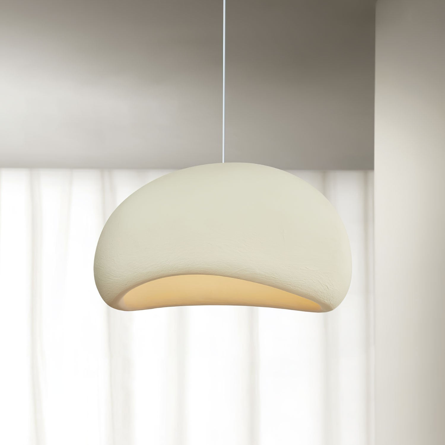 Cloud pendant light hanging from an adjustable cable indoors