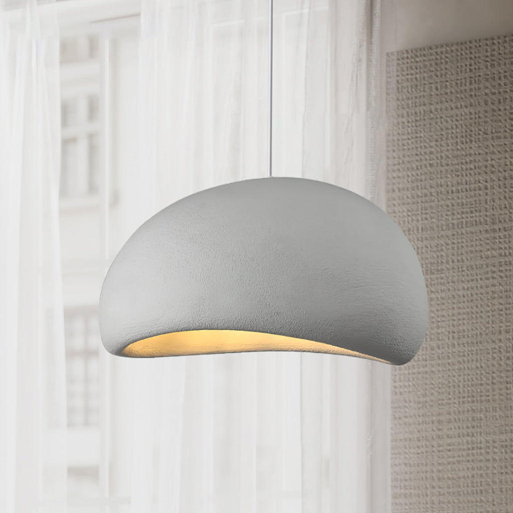 Round cloud pendant light glowing gently in a cozy room
