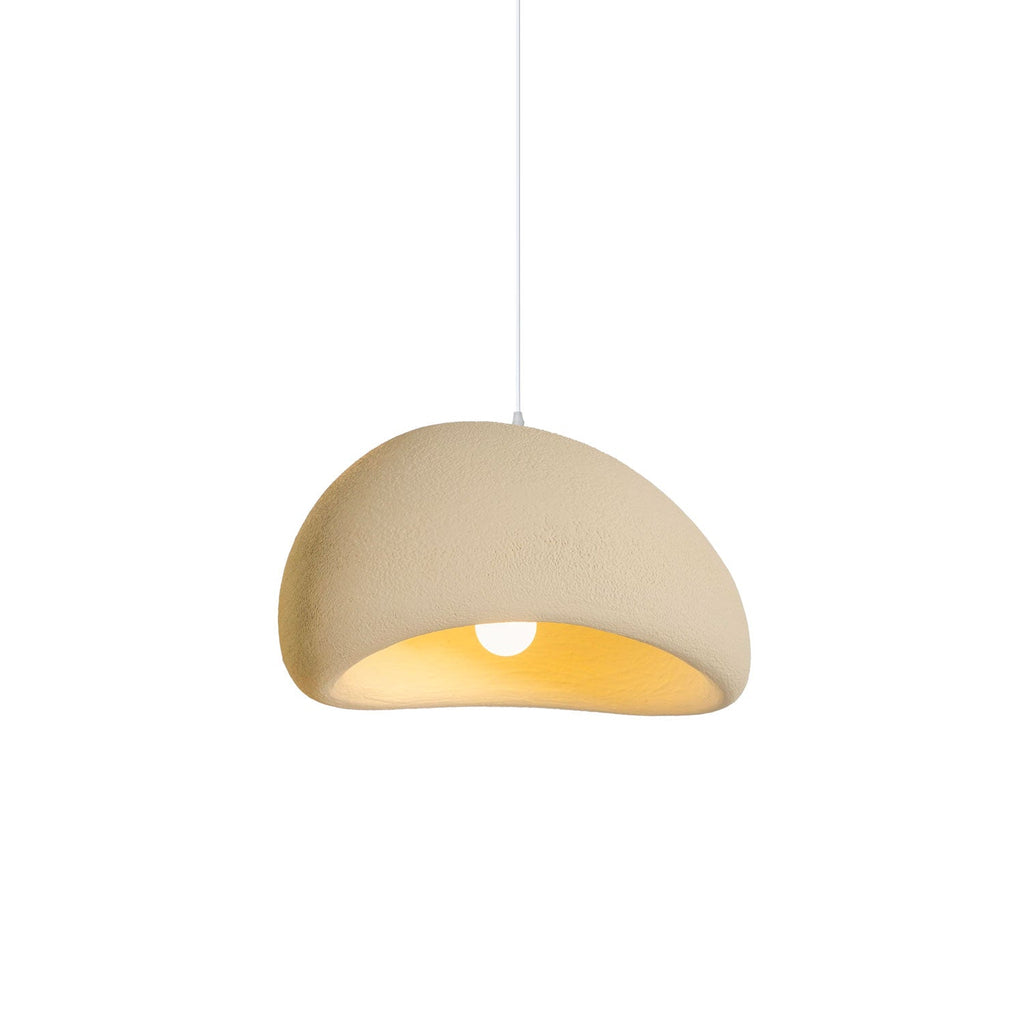 Cloud-shaped pendant light glowing above a table at dusk