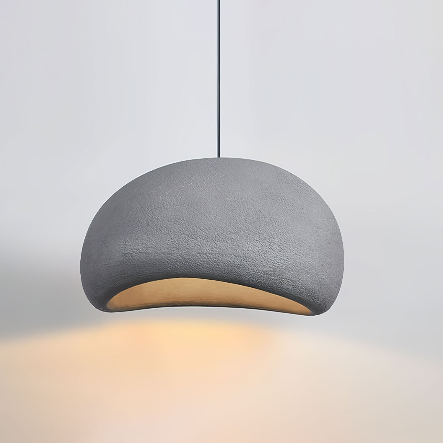 Round cloud pendant light casting diffused glow in a calm room