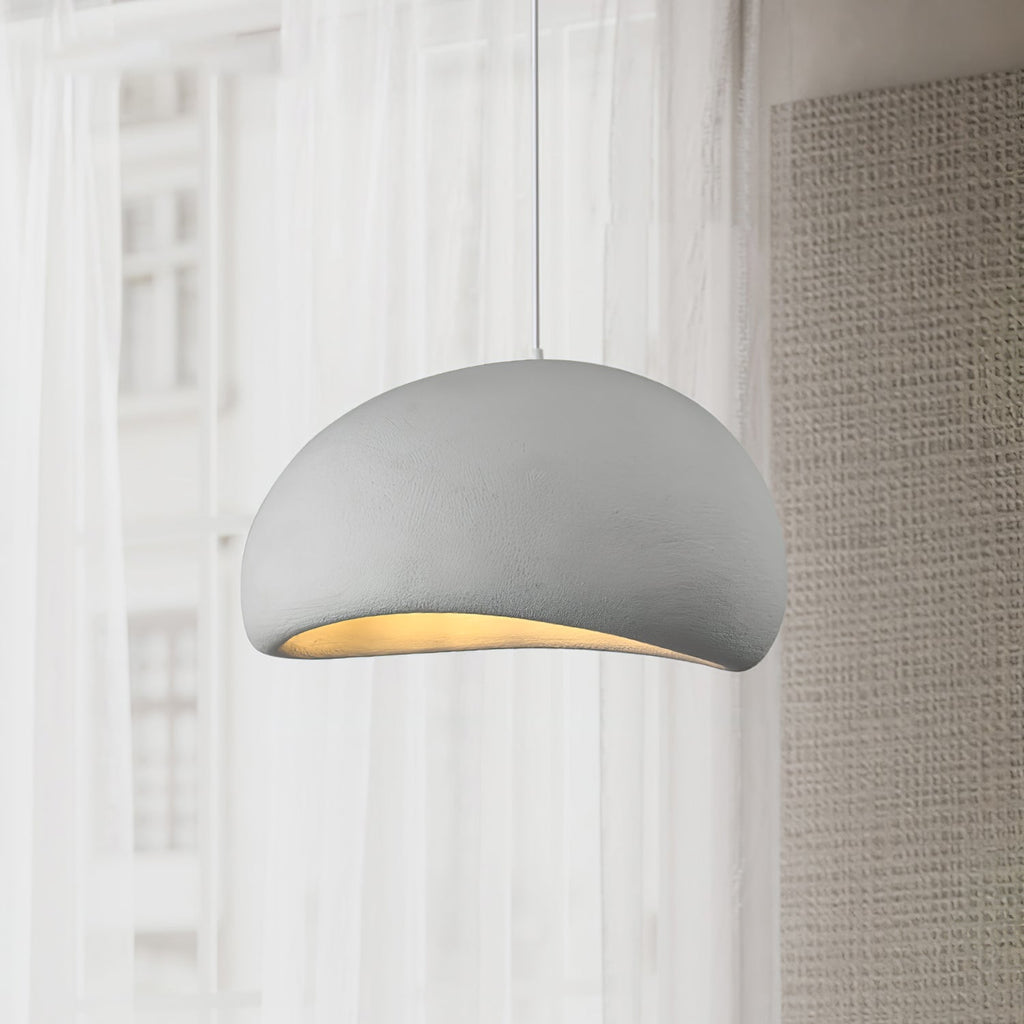 Cloud pendant light hanging low with a soft ambient glow