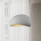 Cloud pendant light hanging low with a soft ambient glow