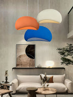 Round cloud pendant light diffusing warm light in a bedroom