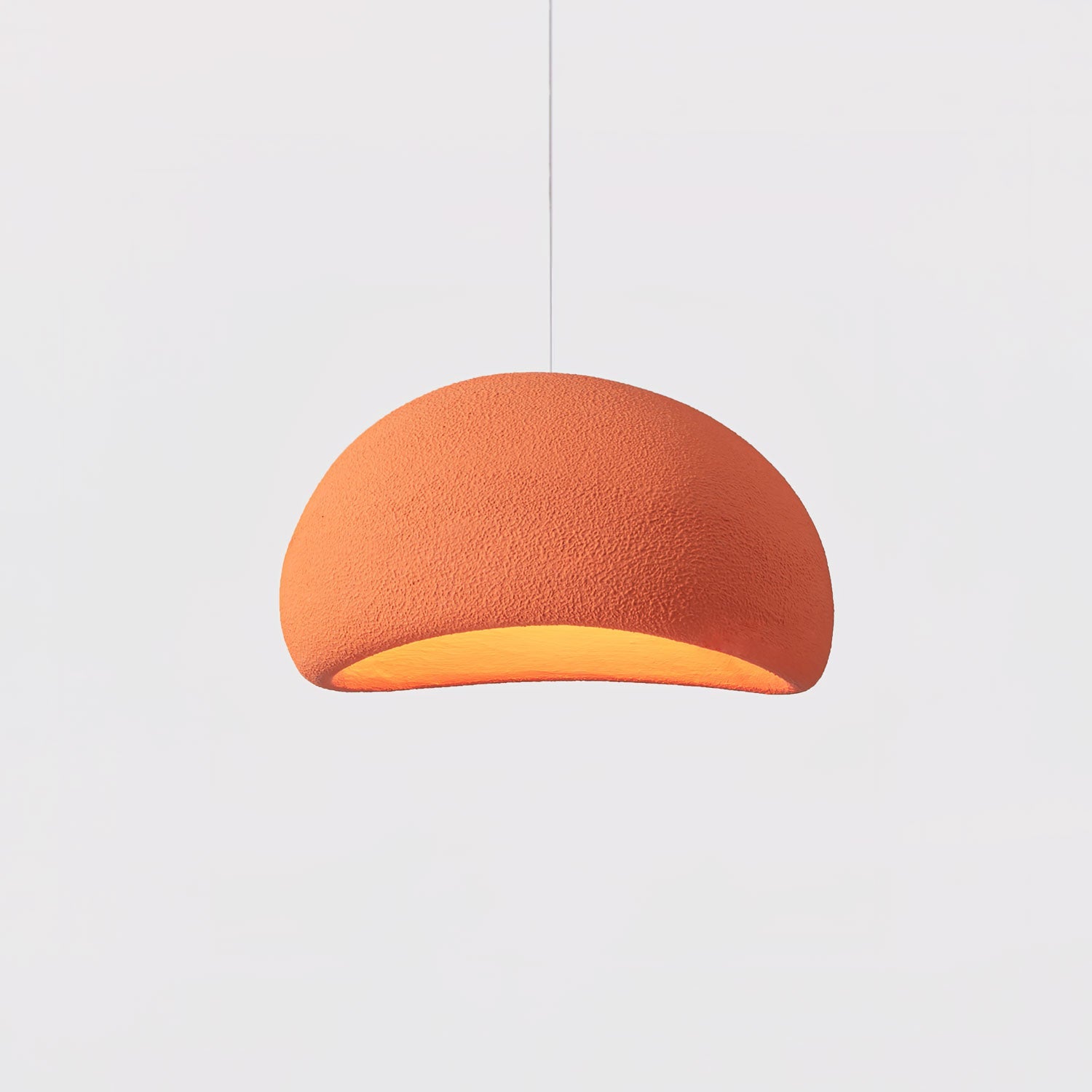 Sphere cloud pendant light glowing gently over a living area