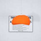Soft cloud-shaped pendant light glowing above a styled interior