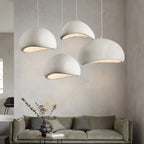 Cloud pendant light suspended low over a dining table