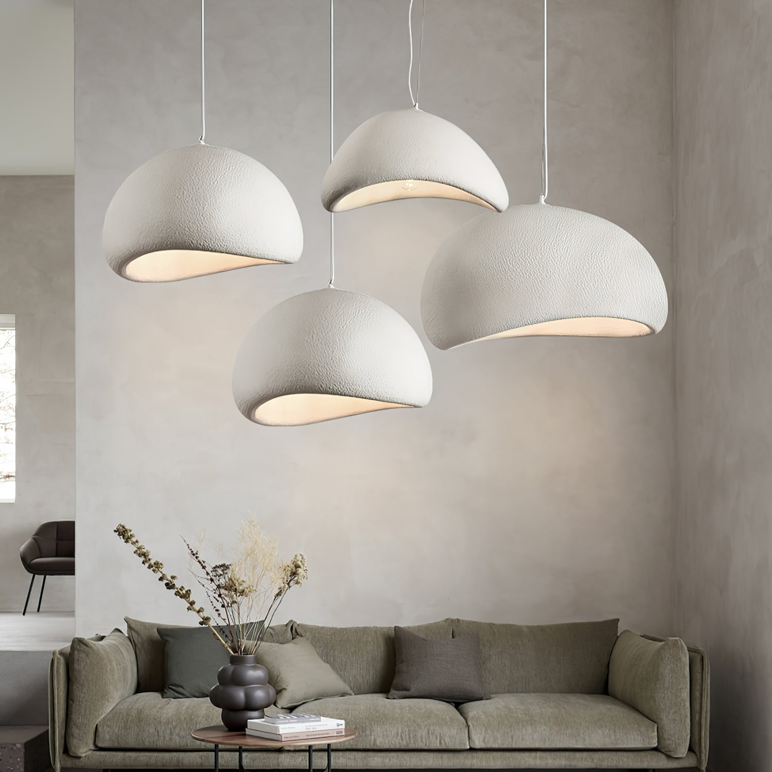 Cloud pendant light suspended low over a dining table