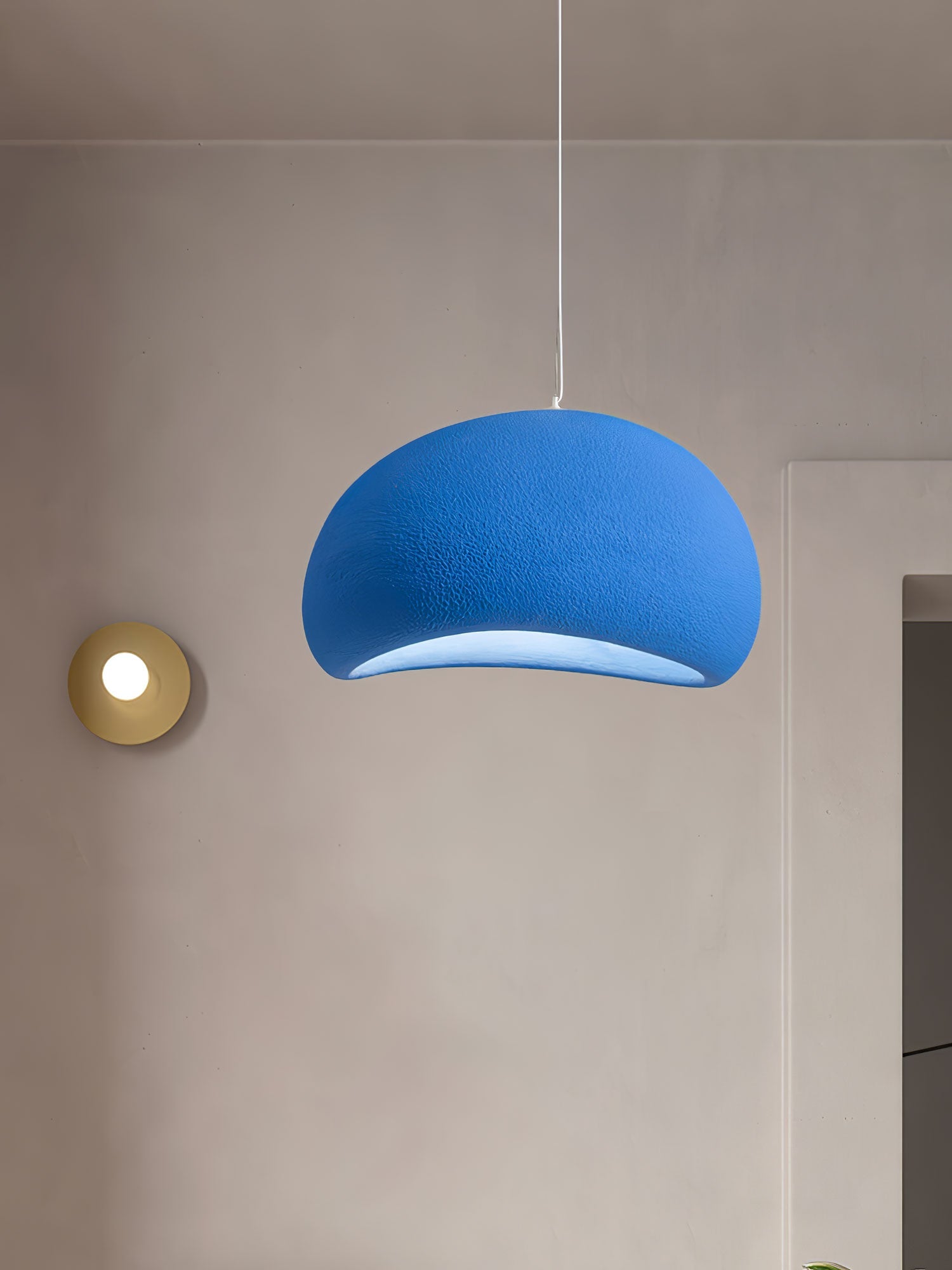 Round cloud pendant light with diffused warm light in a room