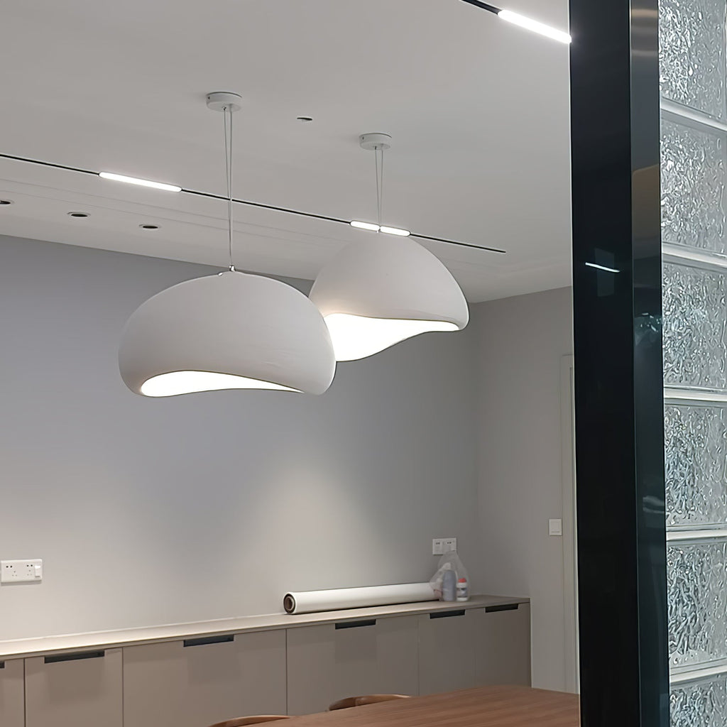 Cloud pendant light suspended above a styled dining table