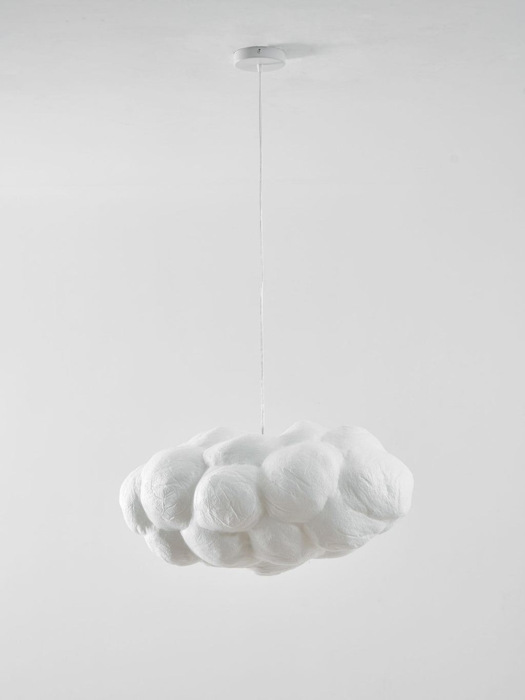 Unlit against plain white, this Clérachic cloud-shaped pendant hangs from its round ceiling canopy.