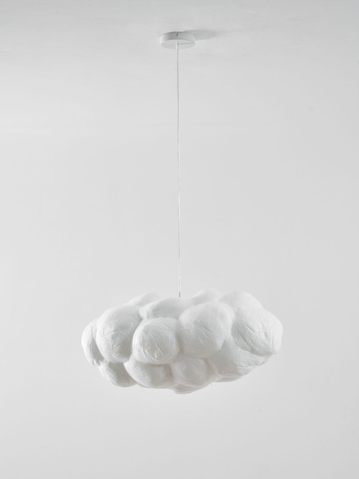 Unlit against plain white, this Clérachic cloud-shaped pendant hangs from its round ceiling canopy.