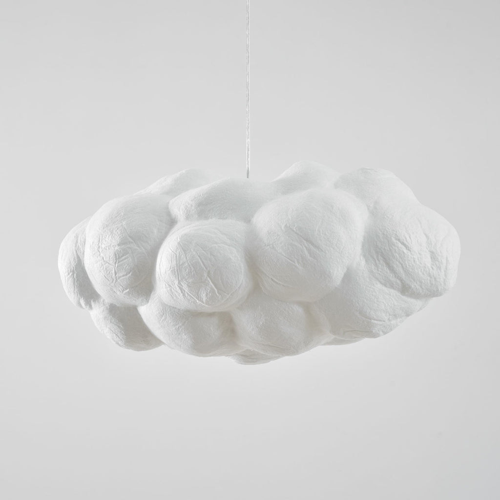 Unlit and shown from the side, this Clérachic cloud-shaped pendant sits against plain grey.