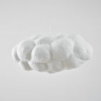 Unlit and shown from the side, this Clérachic cloud-shaped pendant sits against plain grey.
