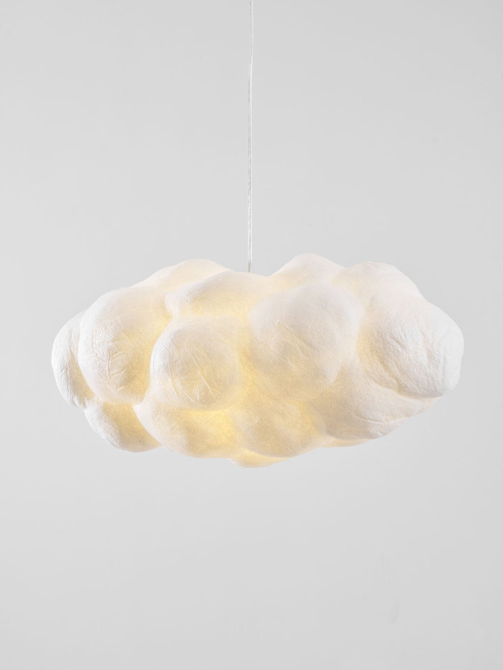 Lit and close up, this Clérachic cloud-shaped pendant shows its puffy, creased fabric lobes.