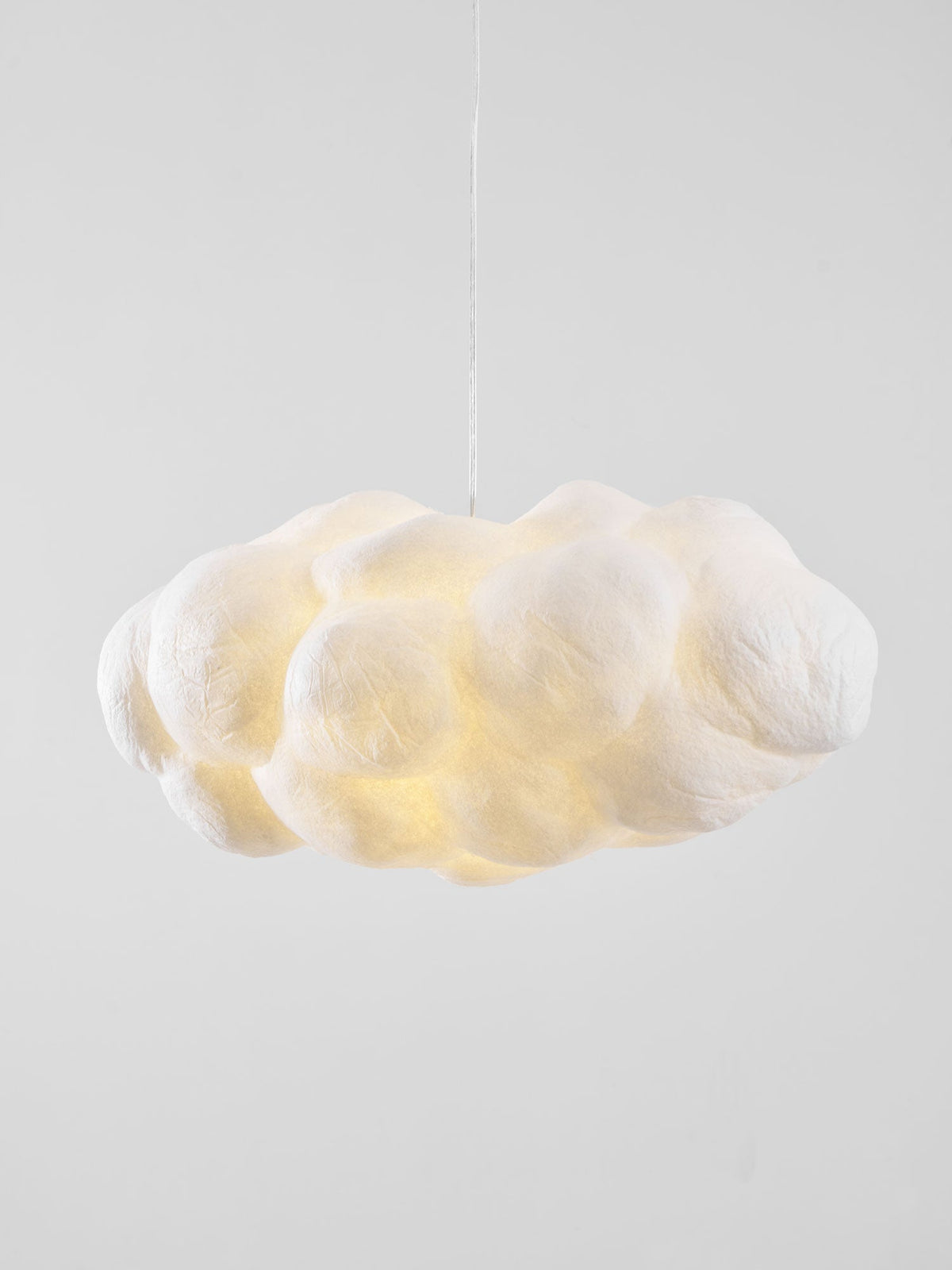Lit and close up, this Clérachic cloud-shaped pendant shows its puffy, creased fabric lobes.