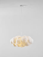 Lit warm against plain white, this Clérachic cloud-shaped pendant drapes from its ceiling mount.