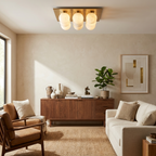 Above a walnut sideboard and leather armchair, this Clérachic ceiling light's globes cluster warm in brushed brass.