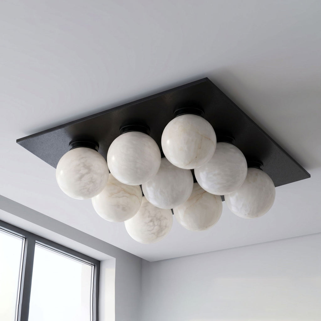 From a close angle on a plain backdrop, this Clérachic ceiling light's globes sit against a matte black canopy.