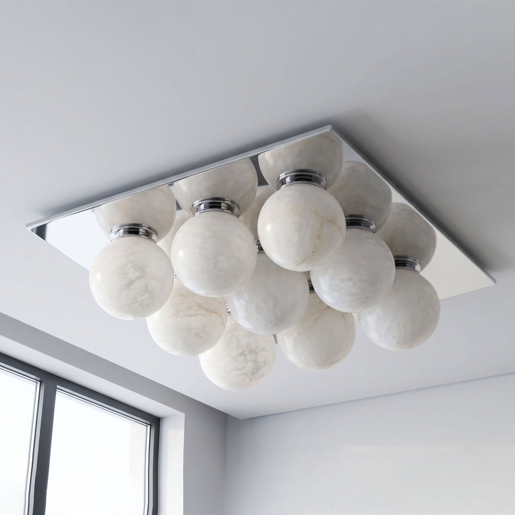 Against a plain white backdrop, the alabaster globes of this Clérachic ceiling light sit on a brushed nickel canopy.