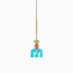A single turquoise ribbed bell shade hangs below a coral bead on this Clérachic pendant, isolated on white.
