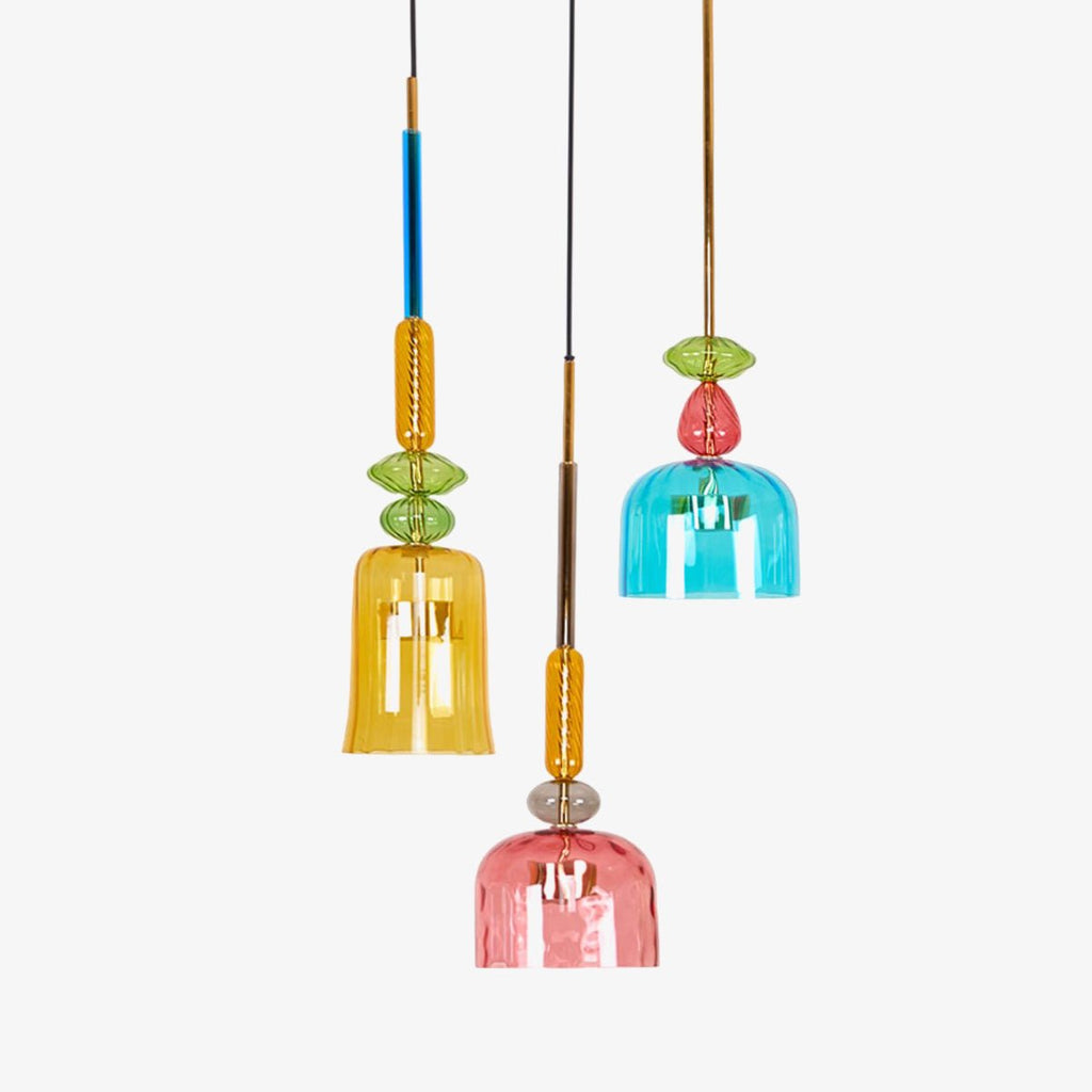 Amber, teal and coral bell shades cluster together at different heights on this Clérachic pendant set, shown on white.