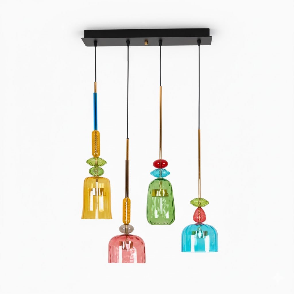 A black rectangular ceiling plate holds four staggered Clérachic pendants in amber, green, teal and coral glass.