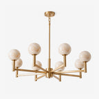 Seen close on a plain backdrop, this Clérachic chandelier's brass arms cross at angles beneath their alabaster globes.