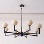 Shown on a plain white background, the matte black frame of this Clérachic chandelier crosses into eight angled arms.