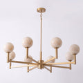 Set on a pale lavender backdrop, this Clérachic chandelier's brass frame holds eight alabaster globes at staggered heights.