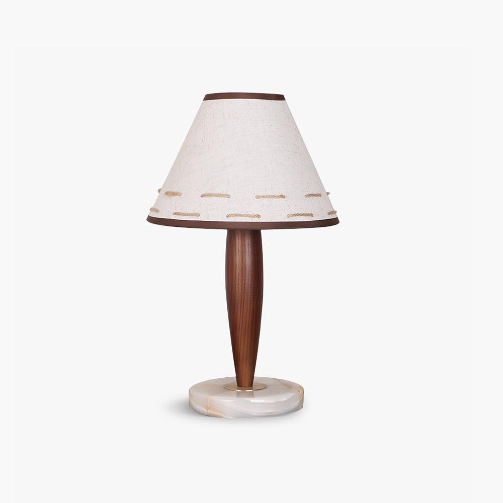 Clérachic linen cone-shade lamp with a tapered walnut stem and round marble base, shown alone against a pale studio backdrop.