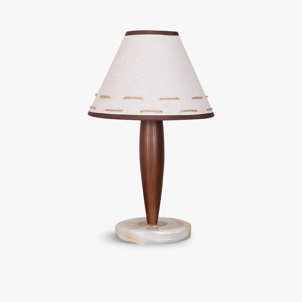 Clérachic linen cone-shade lamp with a tapered walnut stem, photographed in profile against a plain white backdrop.