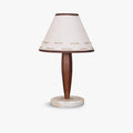 Clérachic linen cone-shade lamp with a tapered walnut stem, photographed in profile against a plain white backdrop.