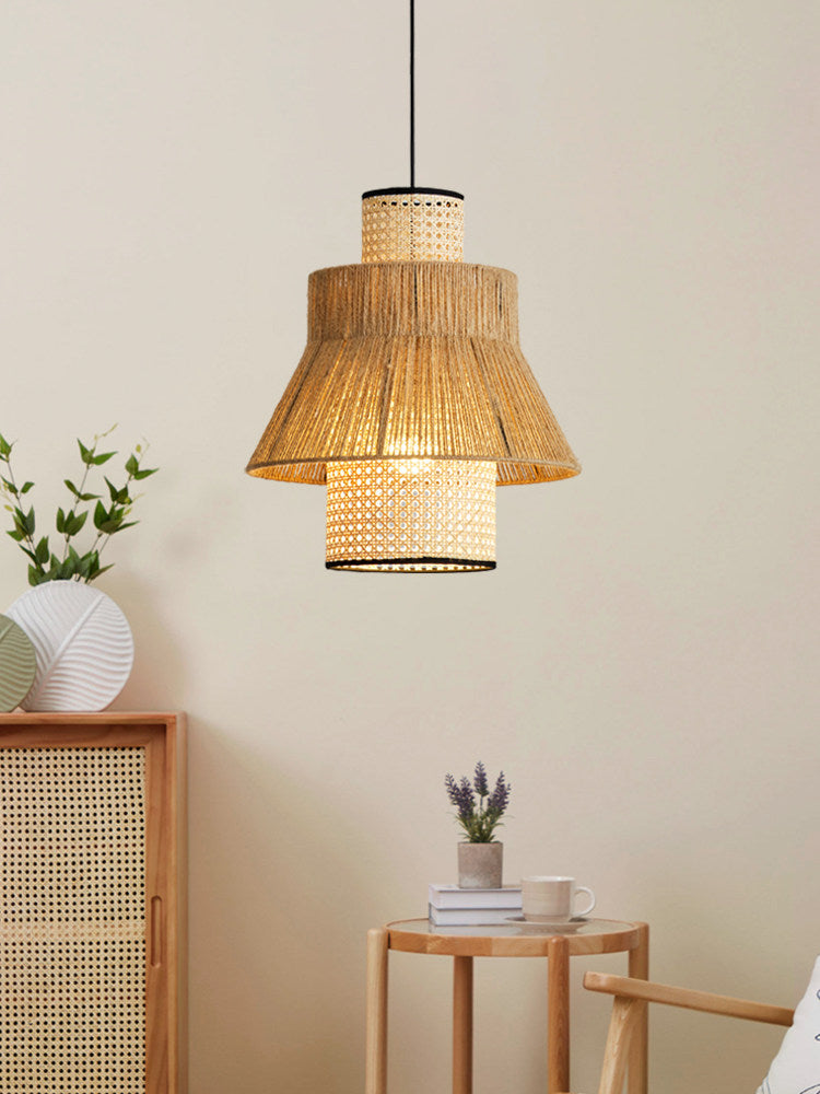 This Clérachic pendant glows above a cane cabinet topped with a paper ball ornament and a small potted lavender.