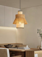 This Clérachic pendant glows warm in a kitchen nook, its light reaching a shelf of books and a ceramic bowl.