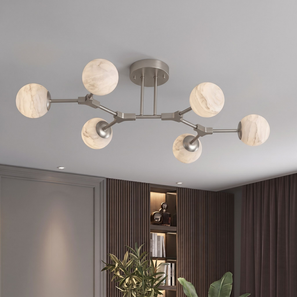 In a dark-paneled room with built-in shelving, this nickel Clérachic chandelier branches its alabaster balls overhead.