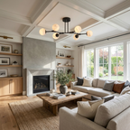 In matte black, this Clérachic chandelier hangs from a coffered ceiling above a sectional sofa and fireplace.