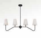 Straight-on against a white backdrop, this Clérachic chandelier's matte black arms fan out to four alabaster cone shades.