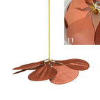 This Clérachic pendant lamp in rust-toned petals is shown from the side, with a close-up inset of the petal edges.