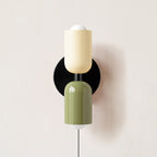 Couleur Double wall lamp casting a soft glow on a wall