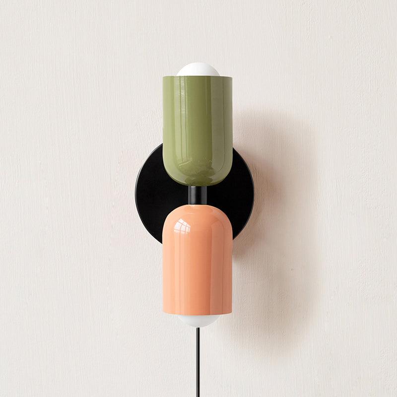 Up and down wall lamp glowing softly in a warm room