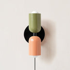 Up and down wall lamp glowing softly in a warm room