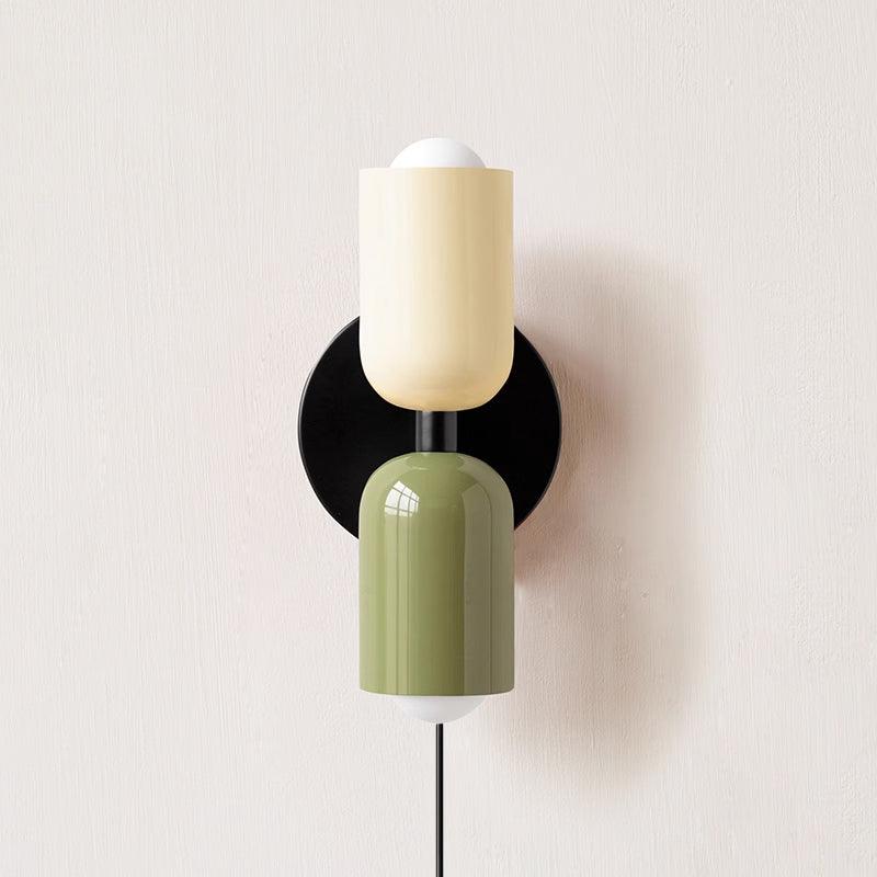 Coloured shade wall lamp lighting a calm interior setting