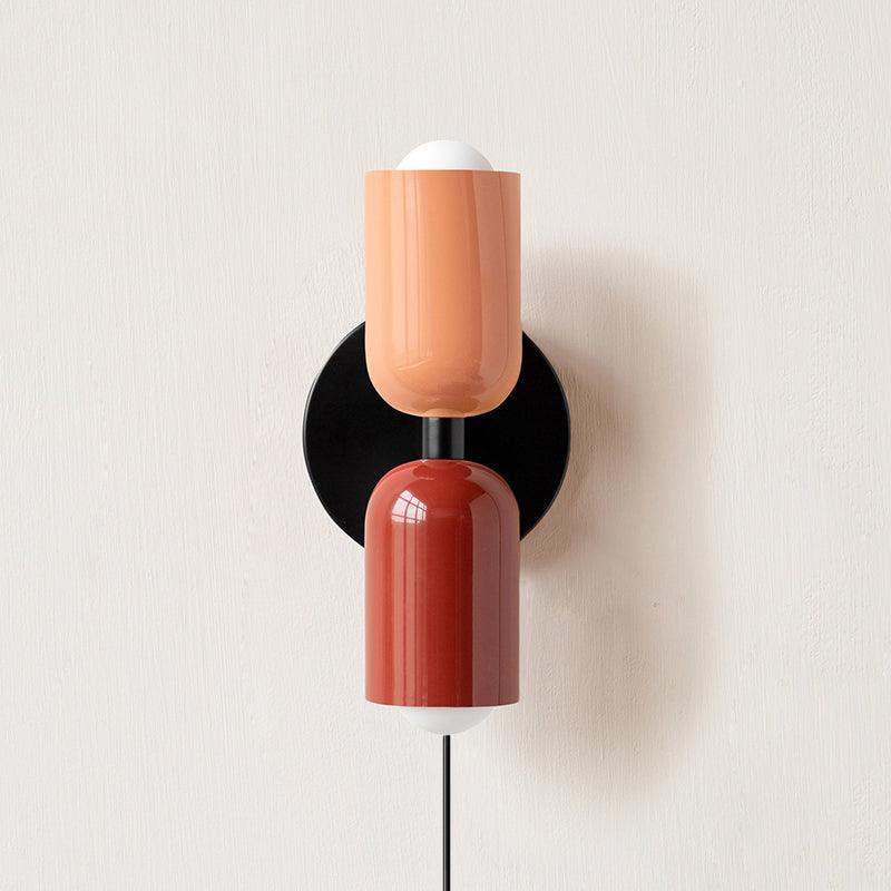 Couleur Double wall lamp shown beside soft home furnishings