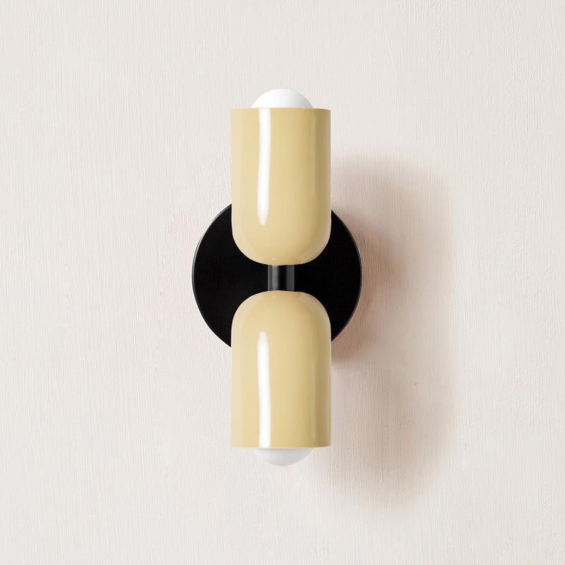 Up-down wall lamp mounted beside a doorway
