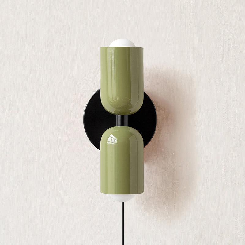 Coloured shade wall lamp glowing gently in a cozy interior