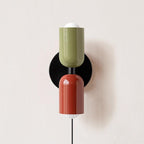 Coloured plug-in wall lamp adding a splash of colour to a room