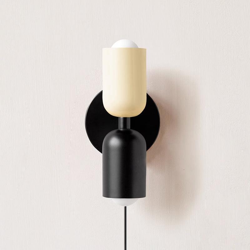 Up and down wall lamp glowing in a softly lit interior