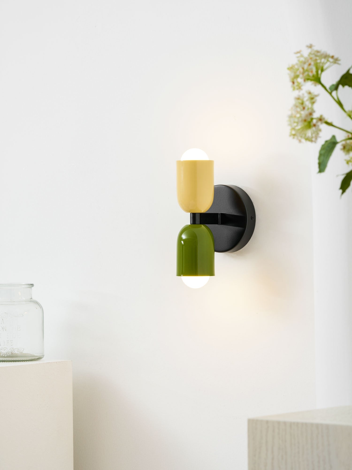 Wall lamp with metal shade mounted in a styled room